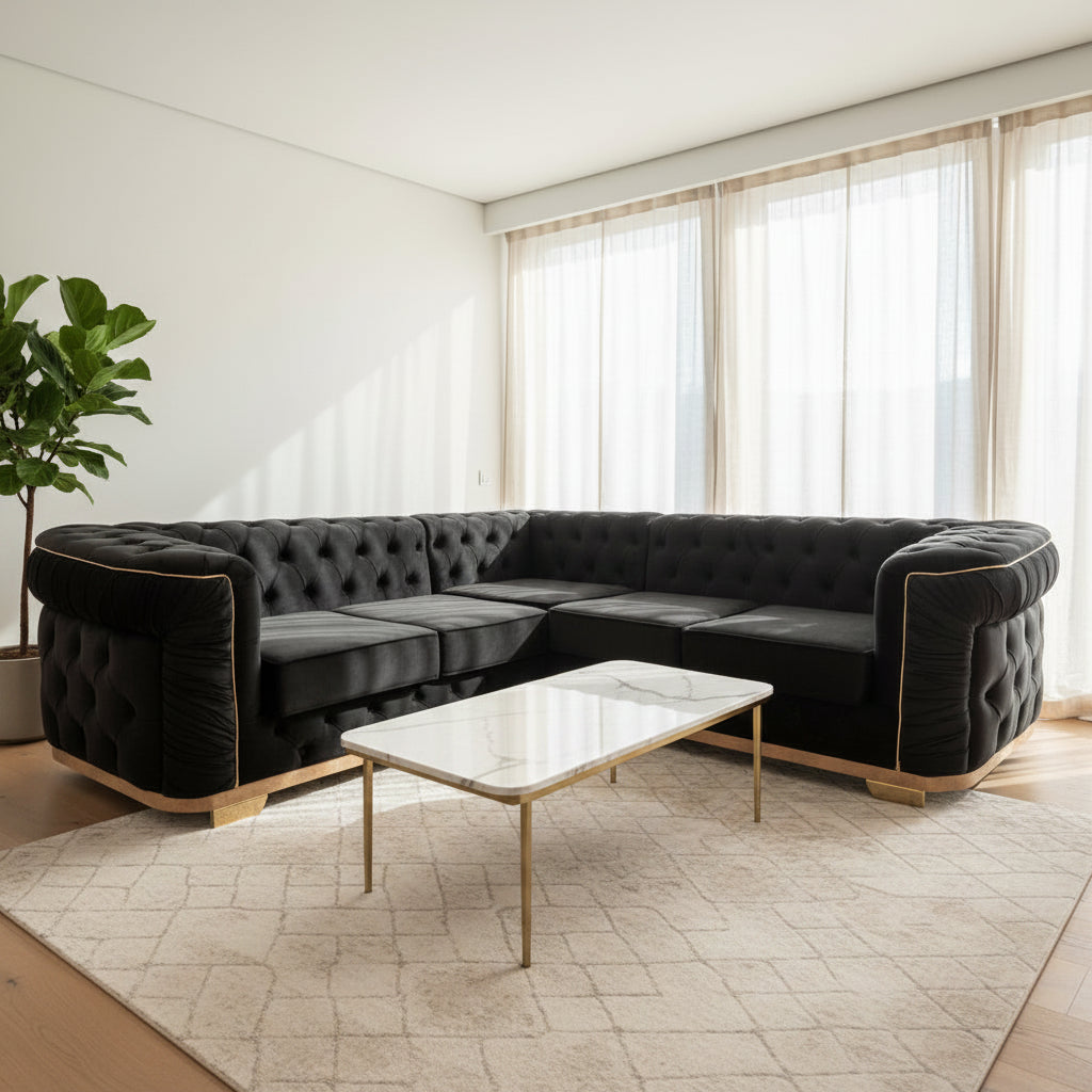 A black tufted sectional sofa with light wood frames, positioned in a minimalist room with light wood floors and large windows with sheer curtains.