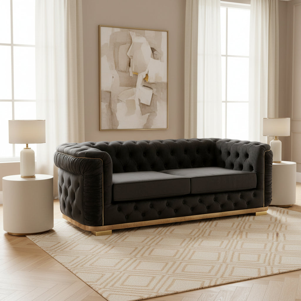 Gray tufted sofa on a black marble floor with 'Velora Living' branding.