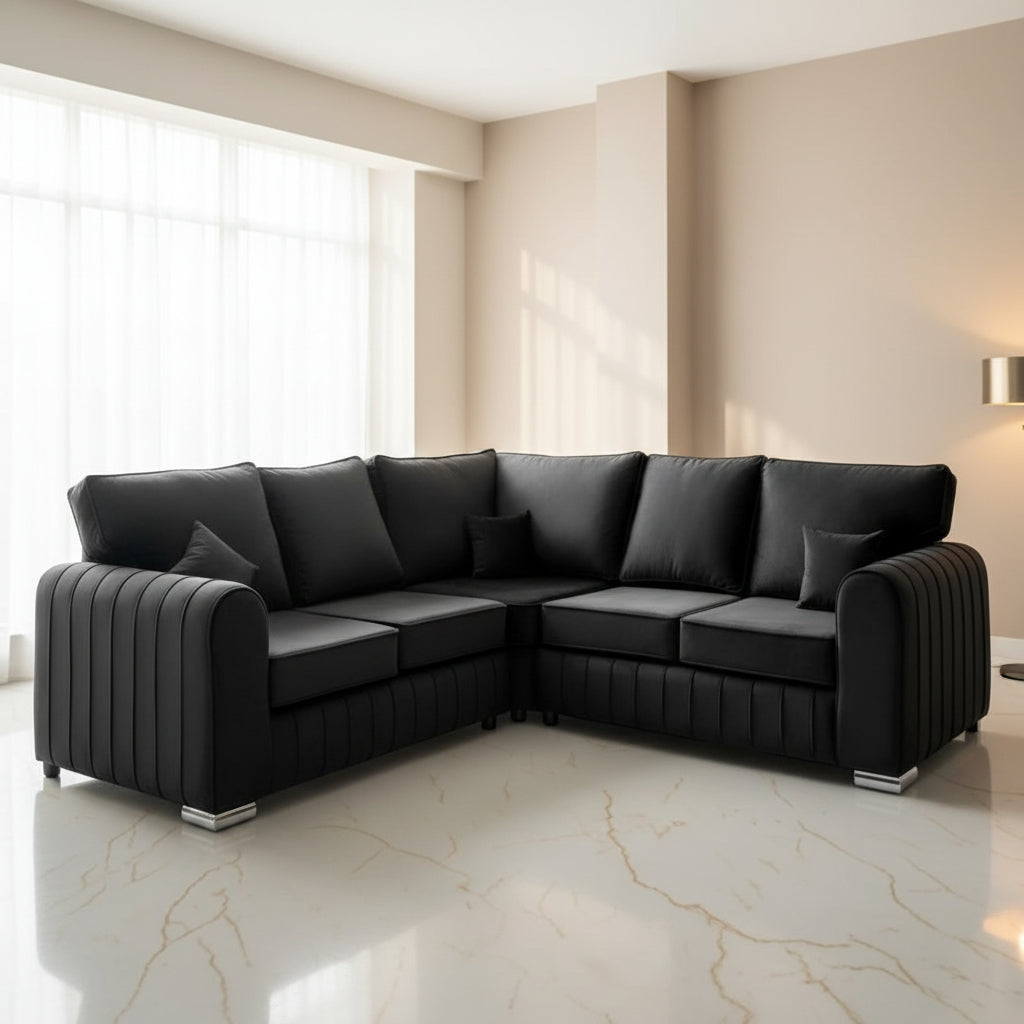 Black sectional sofa with 'Velora Living' branding on a light floor and wall.